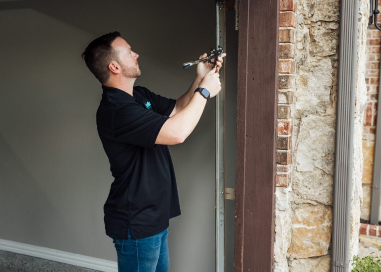 Meadows Staff Installing Garage Door 